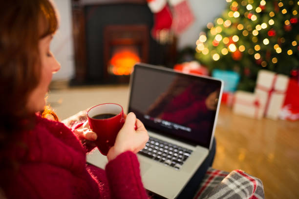 istock Redhead holding hot drink and using laptop 824319596