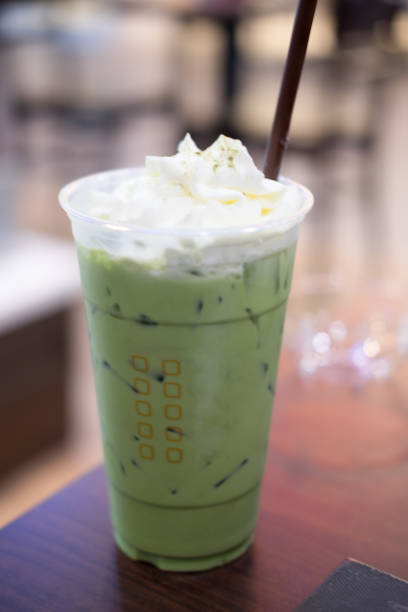 istock Milk green tea cold ice in takeaway cup on wood table 824319776