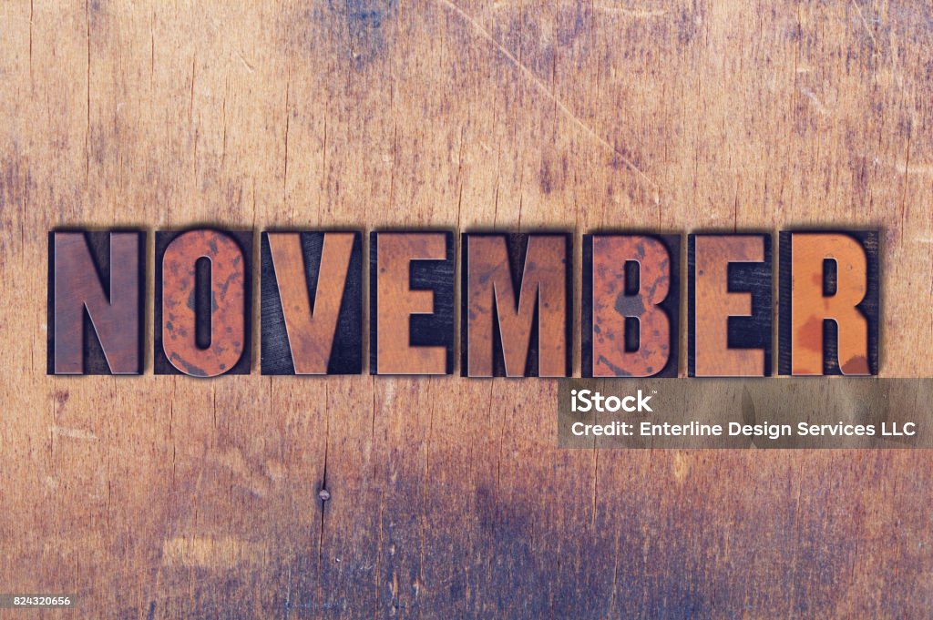 November Theme Letterpress Word on Wood Background The word November concept and theme written in vintage wooden letterpress type on a grunge background. April Stock Photo