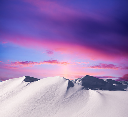 Snowcapped mountains at sunset.