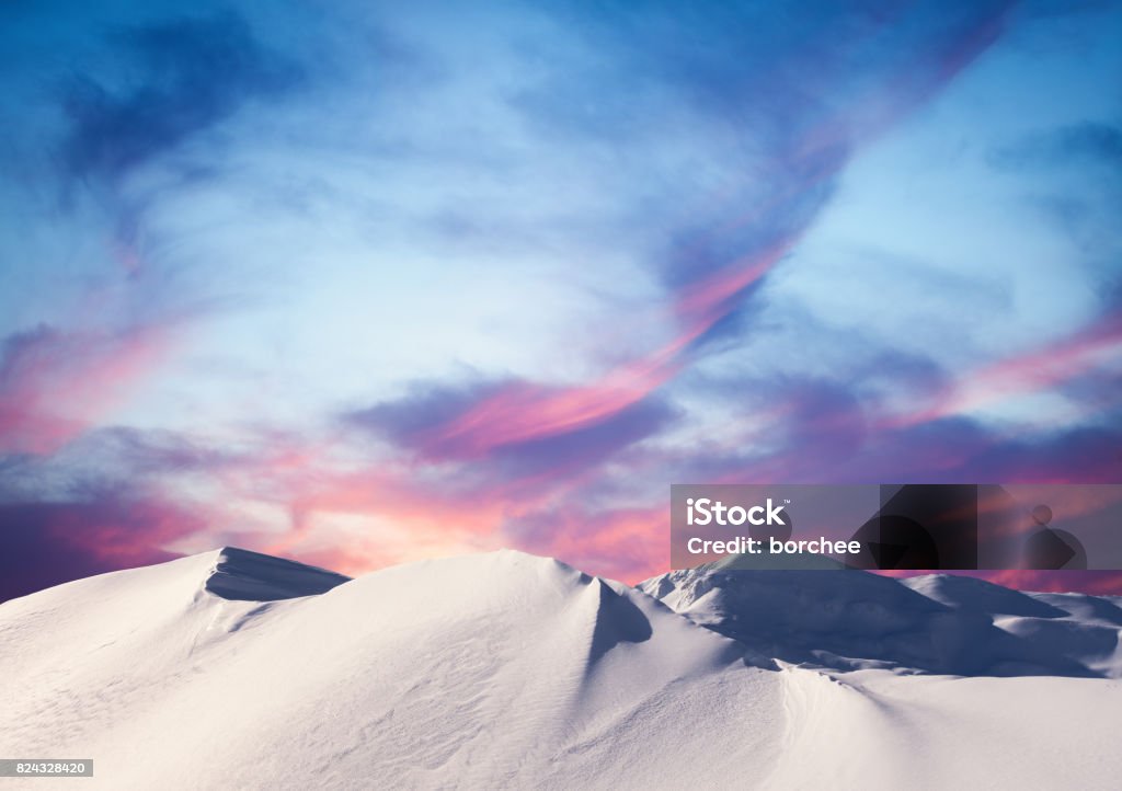 Winter Sunset In The Mountains Snowcapped mountains at sunset. Mountain Stock Photo
