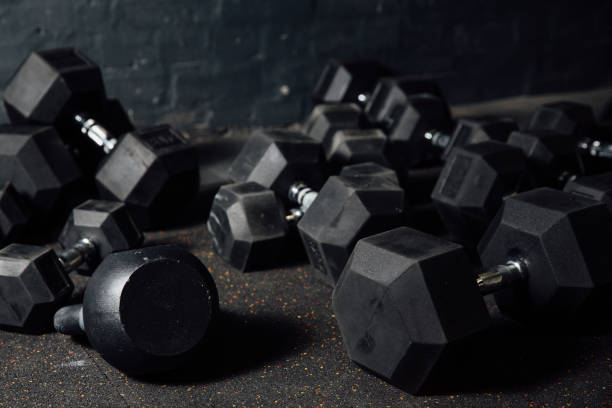 istock Many dumbbells lie randomly on the floor. Loft gym. Place for the text 824333508