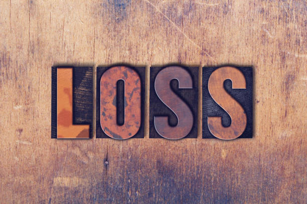 Loss Theme Letterpress Word on Wood Background