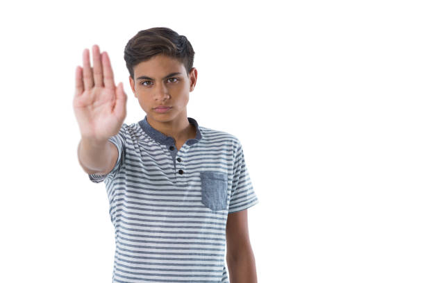 A young man holds his hand up to hide from the camera. Isolated on a white background. http://s3.amazonaws.com/drbimages/m/evamag.jpg