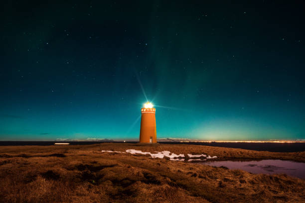 istock Iceland - Orange Lighthouse and Northern Lights 824341138