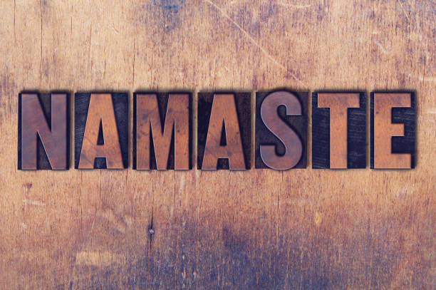 The word Namaste concept and theme written in vintage wooden letterpress type on a grunge background.