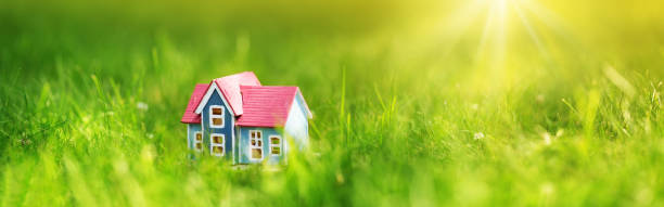 istock red wooden house on the grass 824342836
