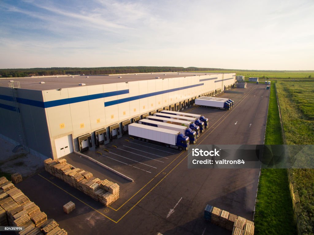 distribution warehouse with trucks of different capacity distribution warehouse with trucks of different capacity. Warehouse Stock Photo