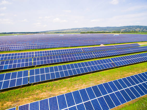 istock close-up of solar panels on green grass with blue sky 824352180