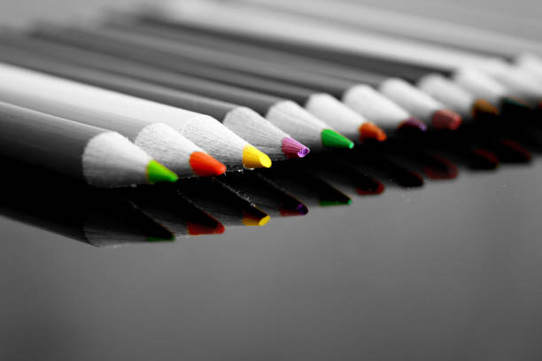 colorful pencils arranged in a different position on different backdrops and surfaces.