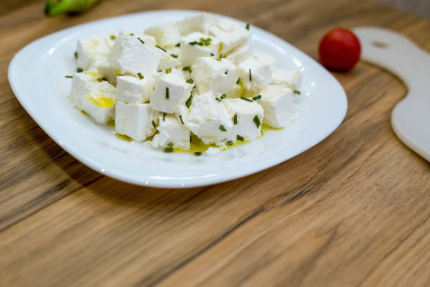 Fresh Feta Cheese (detailed close-up shot) on vintage background