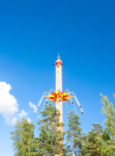 istock Ride in motion at amusement park on blue sky background. 824369358