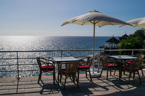 Table and chairs with umbrella and a beautiful sea view, Tenerife, Costa Adeje, canary islands, Spain