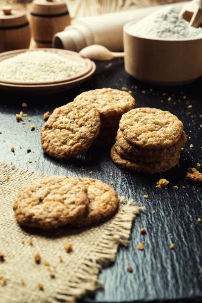 istock Biscuit sweet cookie background. Domestic stacked butter biscuit pattern concept,close up macro.Homemade cookies on wooden table.Cereal biscuits with the sesame,peanuts,sunflower and amaranth. 824373968