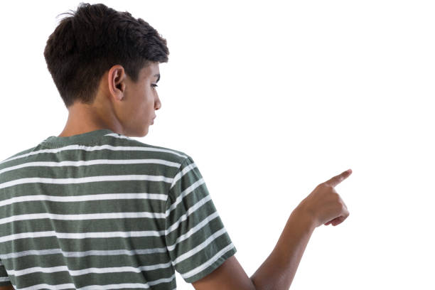 istock Teenage boy pressing an invisible virtual screen against white background 824377278