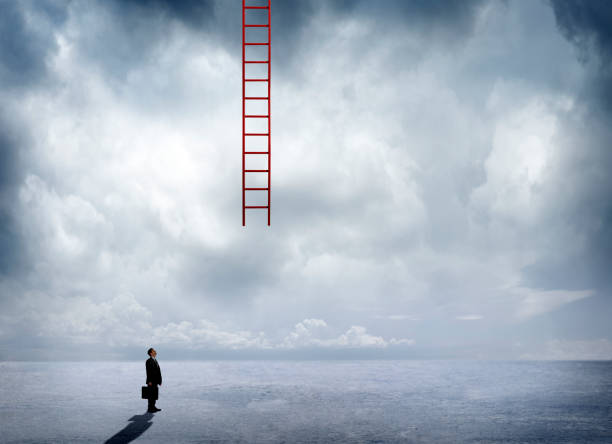 istock Businessman Looking Up At Ladder Hanging Down From Sky 824377984