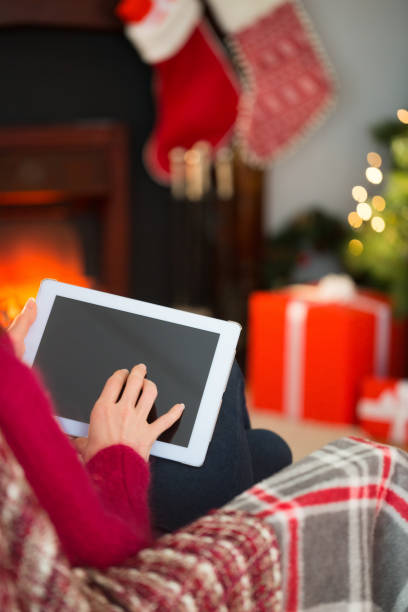 istock Red hair touching digital tablet at christmas 824378144