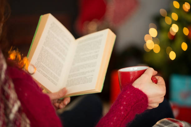 istock Woman in jumper reading and drinking coffee 824378362