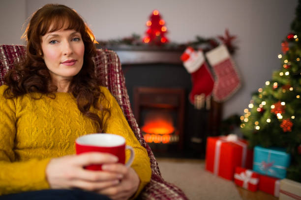istock Pretty redhead enjoying hot beverage at christmas 824378462