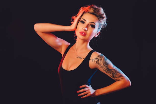 istock Beautiful female model posing at studio in the light flashes 824378972