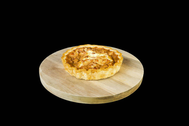 istock Quiche Lorrainne on a wooden board and Isolated on black 824384152