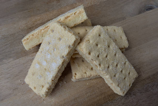 istock Shortbread Biscuits covered in sugar and isolated on black and served on a wooden board 824384564