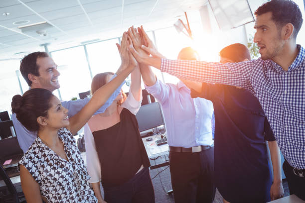 istock Happy business colleagues putting their hands together 824385636