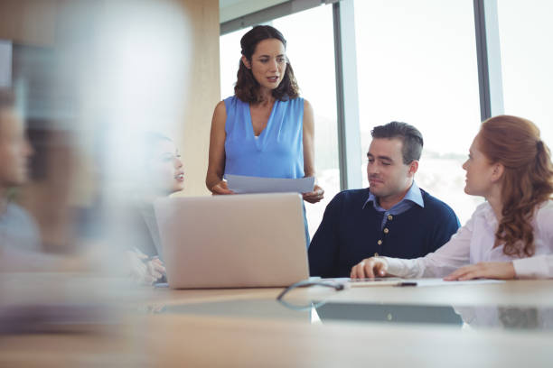istock Colleagues discussing at desk during business metting 824390028