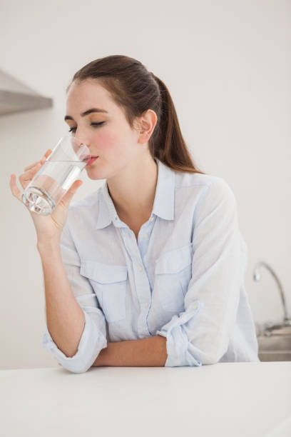 istock Pretty brunette drinking glass of water 824392586