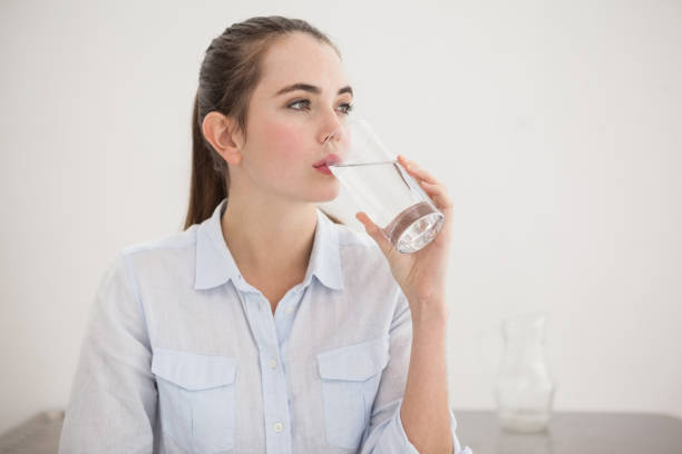 istock Pretty brunette drinking glass of water 824392606