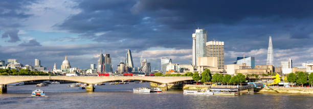 Dramatic clouds above St Paul's Cathedral, City of London and The Shard at sunset Panoramic view of St Paul's Cathedral, City of London and The Shard at sunset. Composite of 3 images. waterloo bridge stock pictures, royalty-free photos & images