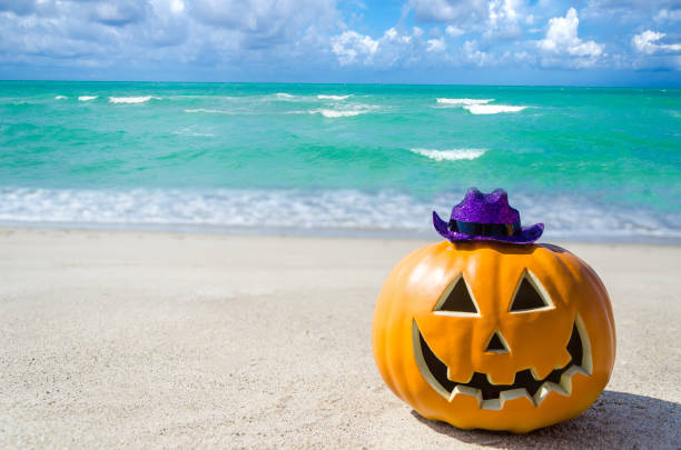 istock Halloween pumpkin background on the beach 824404234