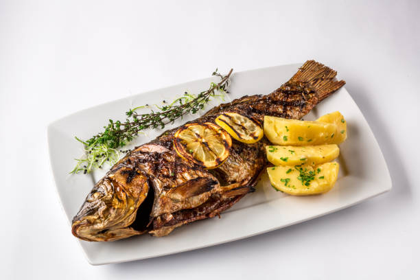 ローズマリー ポテトとレモン、グリルド カープ魚をクローズ アップ - prepared fish fish grilled close up ストックフォトと画像