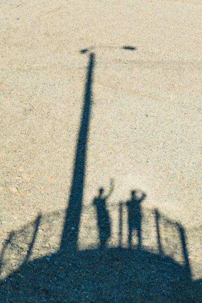istock Shadow of man and woman on a sand 824499178