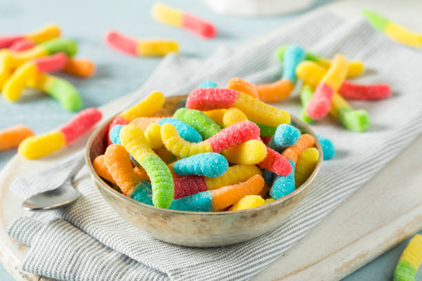 süß sauer neon gummy worms - sweet food sugar vibrant color multi colored stock-fotos und bilder