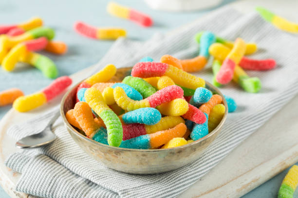 Sweet Sour Neon Gummy Worms Sweet Sour Neon Gummy Worms with a Sugar Coating bitter stock pictures, royalty-free photos & images