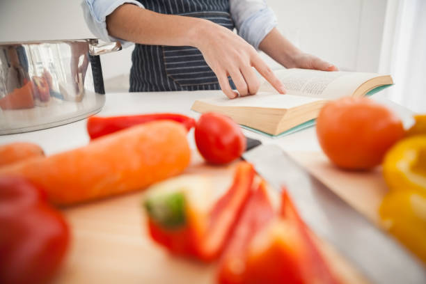 istock Woman following a recipe in book 824556426