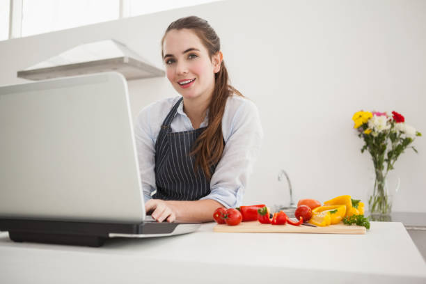 istock Pretty brunette following online recipe 824556440
