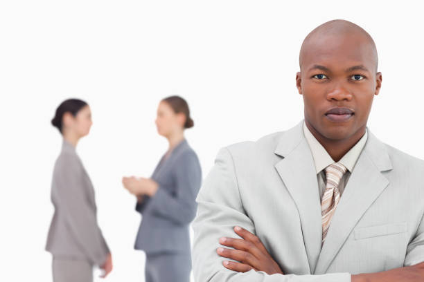 istock Tradesman with folded arms and colleagues behind him 824559380