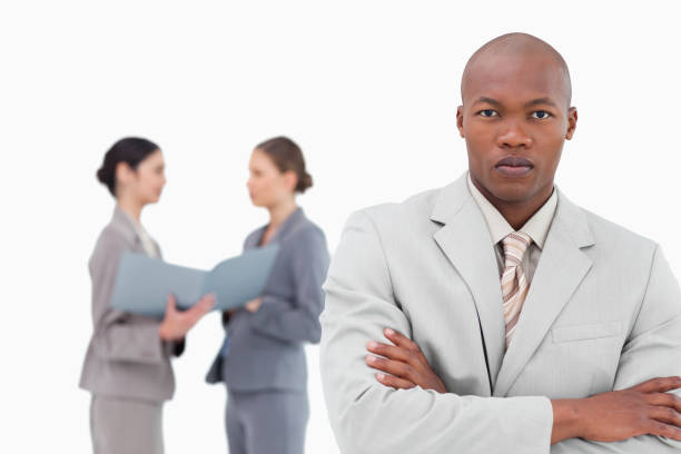 istock Serious tradesman with colleagues behind him 824559424