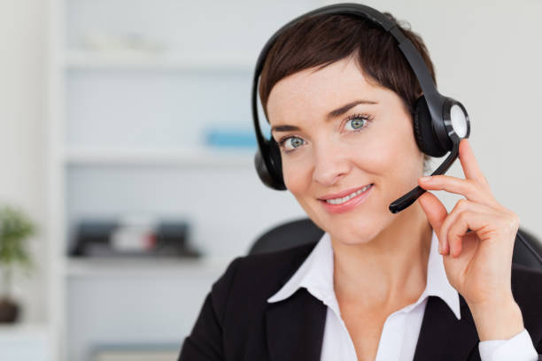 istock Close up of a smiling secretary calling with a headset 824561052