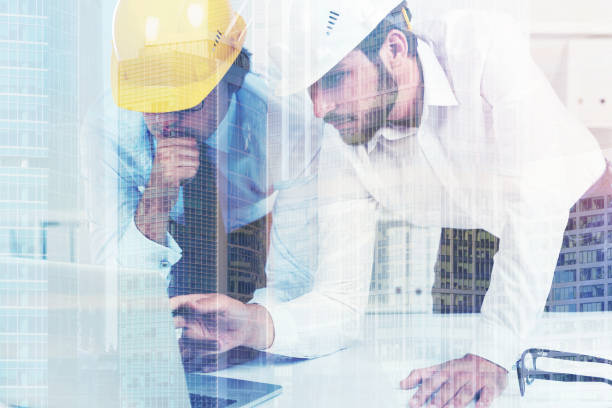 istock Two architects in hardhats in an office, double 824564828