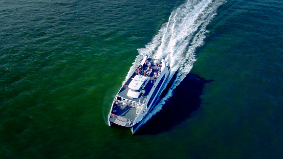 The top view directly above aerial drone photo of the passenger boat at  Hudson River, New York, USA