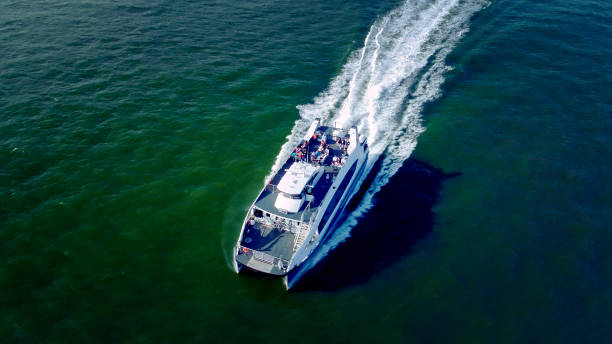 The top view directly above shot of the passenger boat at  Hudson River, New York, USA The top view directly above aerial drone photo of the passenger boat at  Hudson River, New York, USA watertaxi stock pictures, royalty-free photos & images