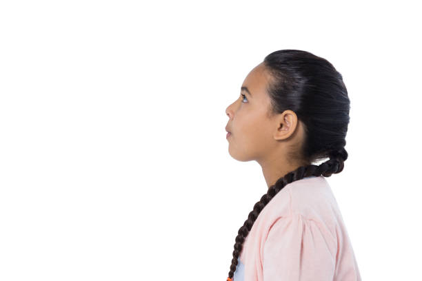 istock Thoughtful girl standing against white background 824572152