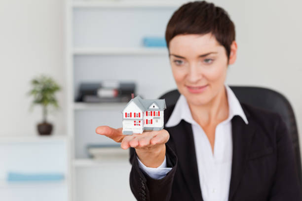 Woman's Hands Holding a Little House