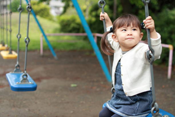 istock Japanese girl on the swing (2 years old) 824576526