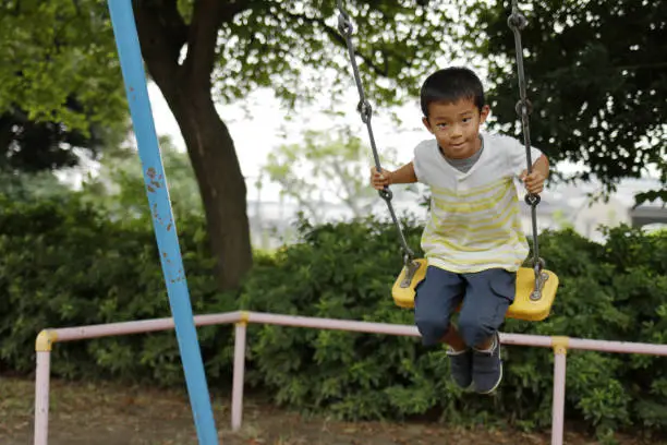 Photo of Japanese boy on the swing (second grade at elementary school)