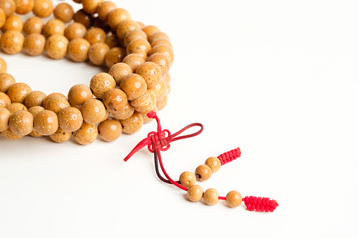 Buddhist reciting beads on white background