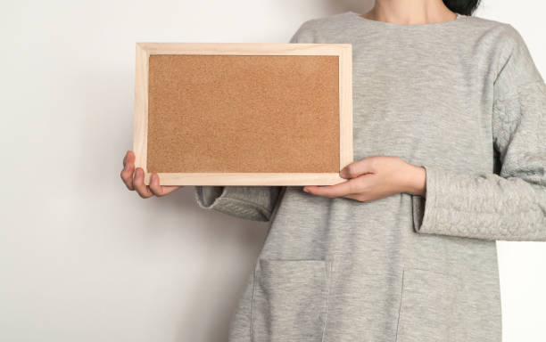 istock Woman holding a cork board 824583914